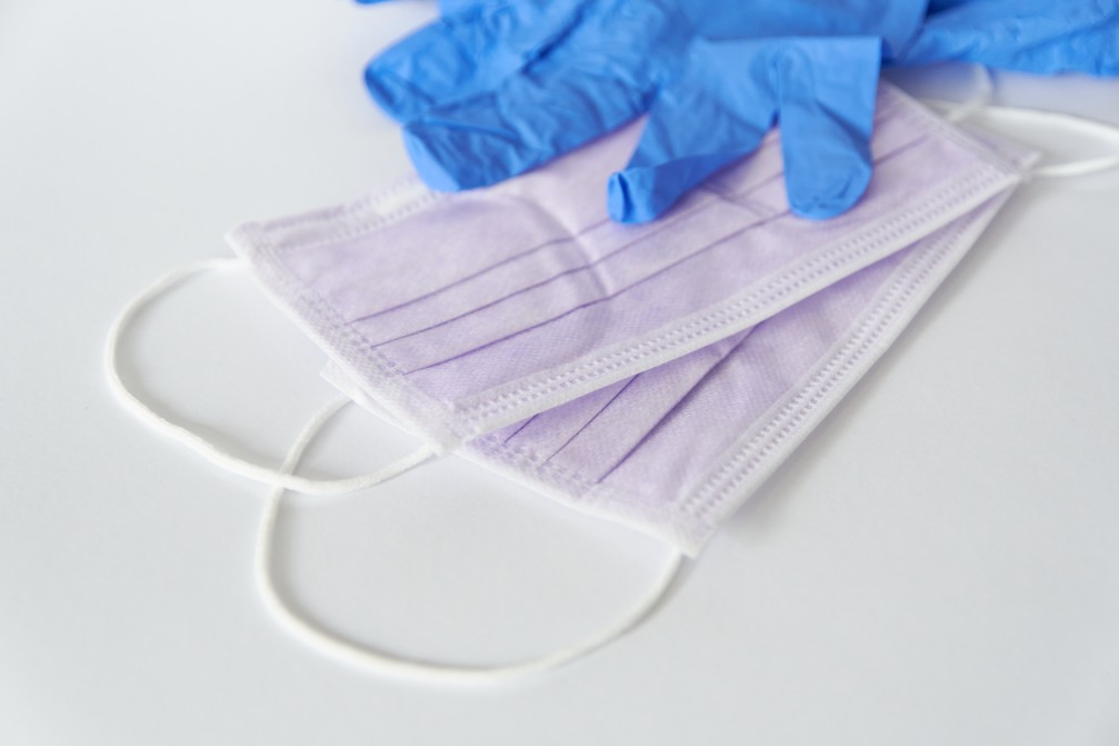 surgical masks and gloves on white background