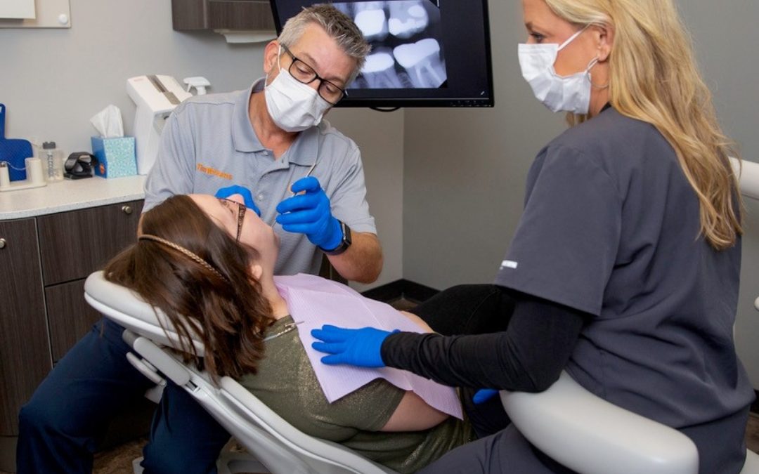 a knoxville dentist examining a patient who needs specialized dental care due to their diabetes
