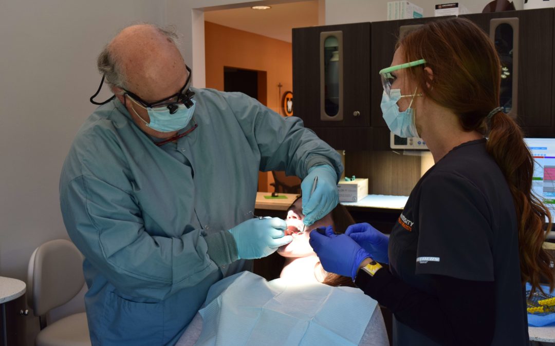 knoxville dentist checking a patient's mouth for cavities